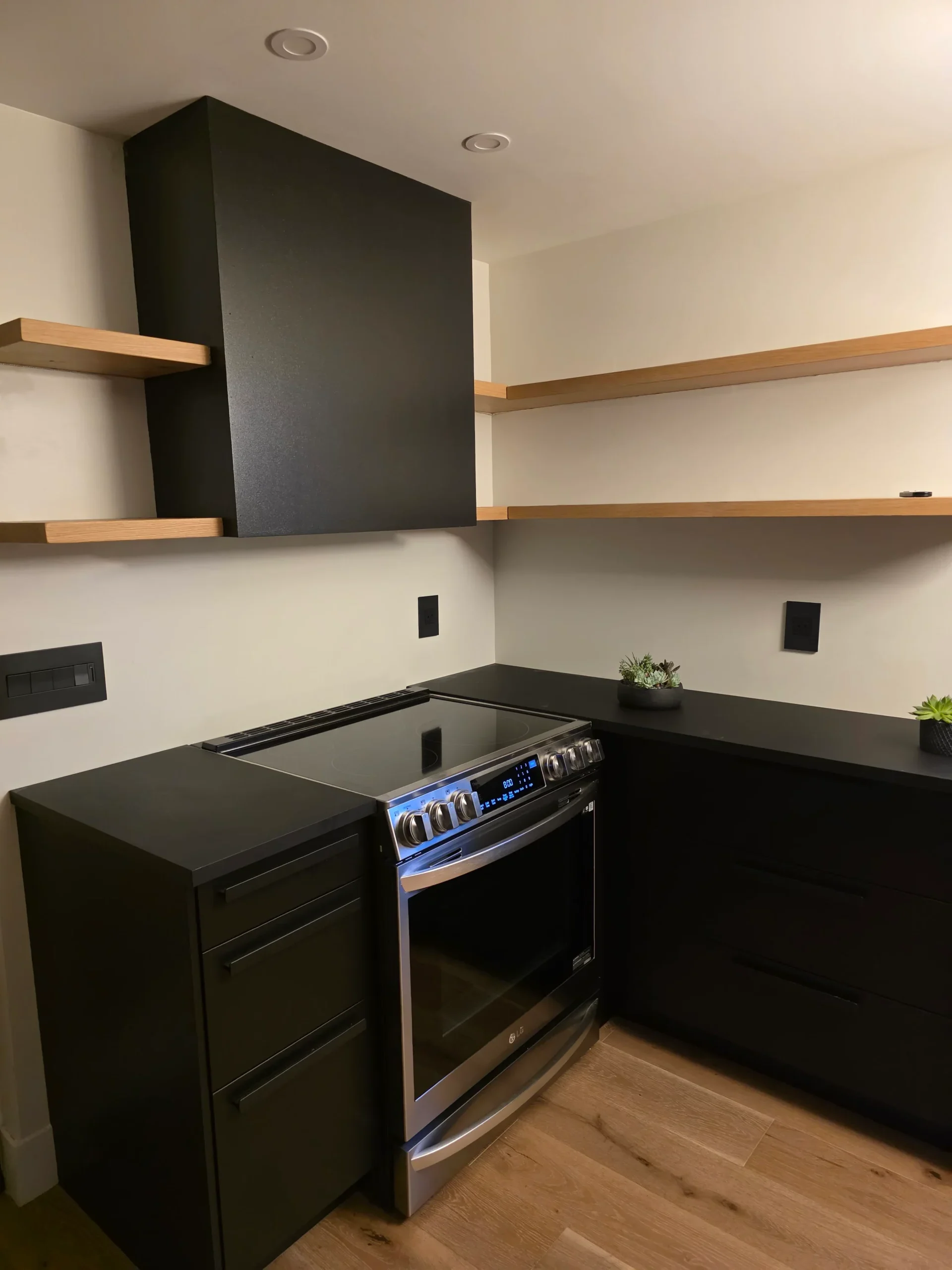 Finished modern kitchen with dark cabinetry and new flooring