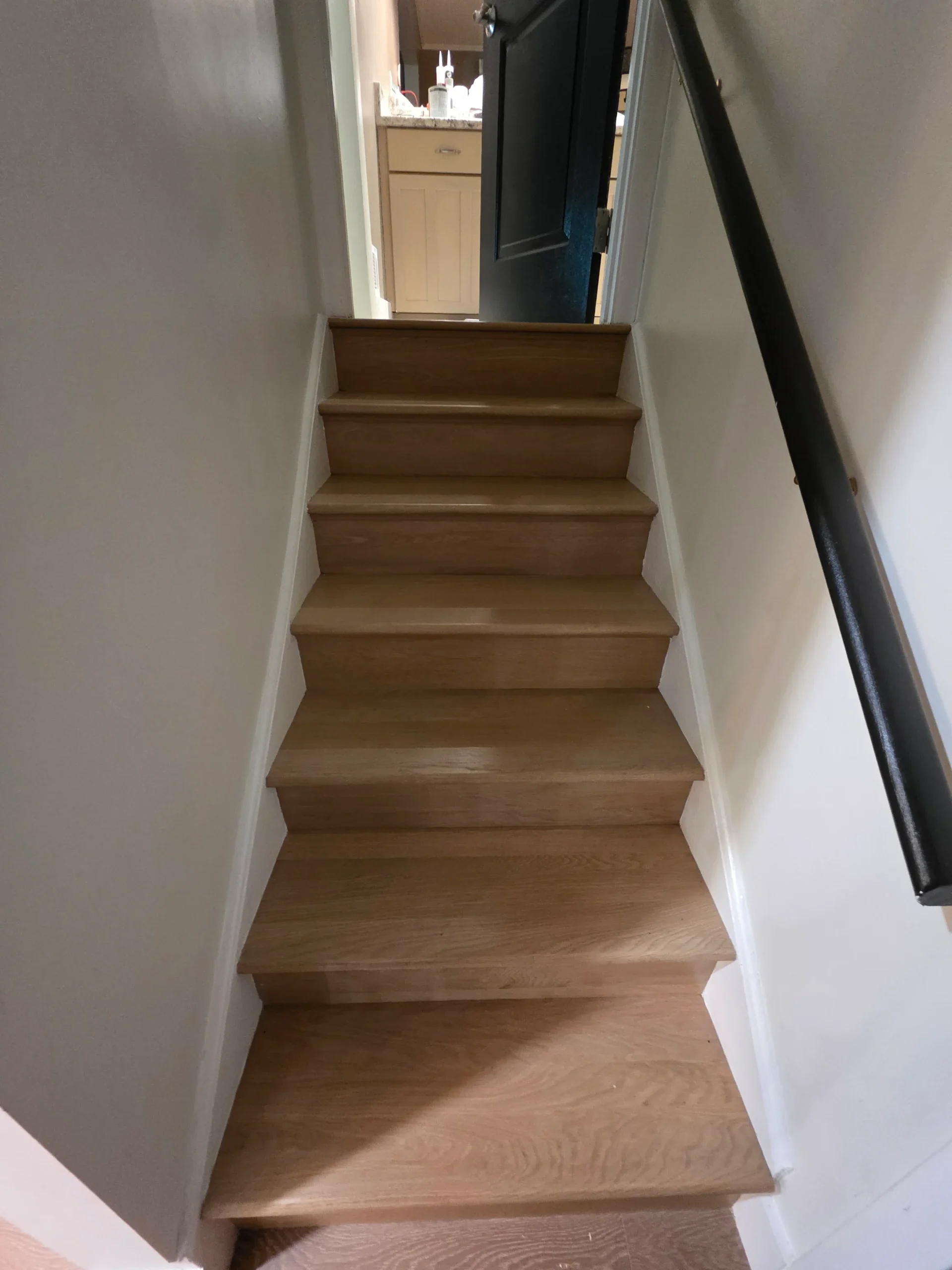 Wood stair treads and white risers finished by FIXO