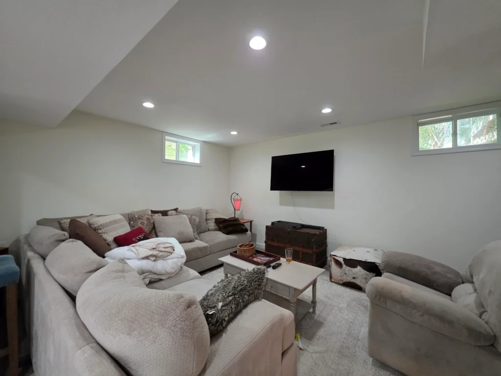 Waterproof basement flooring installed across a finished lower-level living room