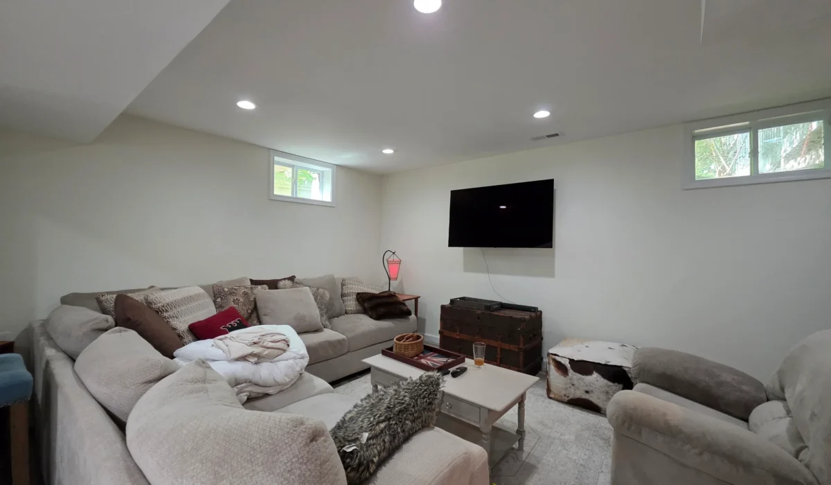 Finished lower-level living room with new flooring throughout