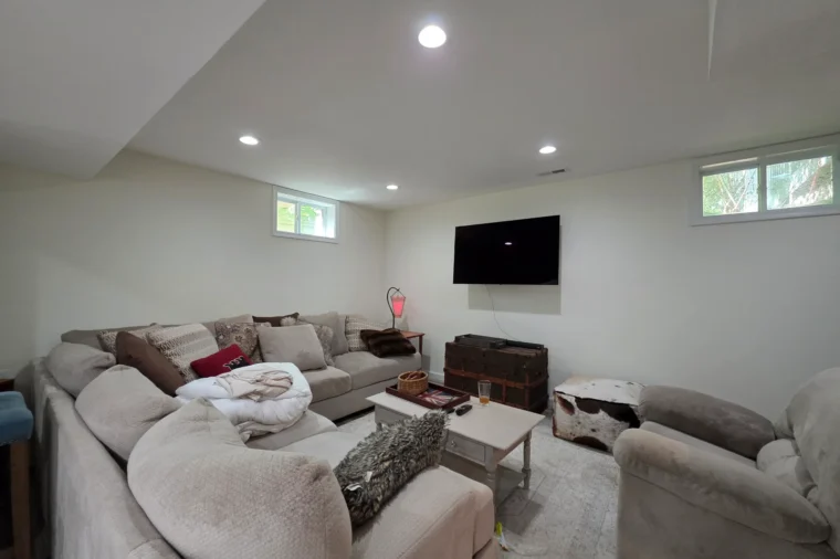 Finished lower-level living room with new flooring throughout