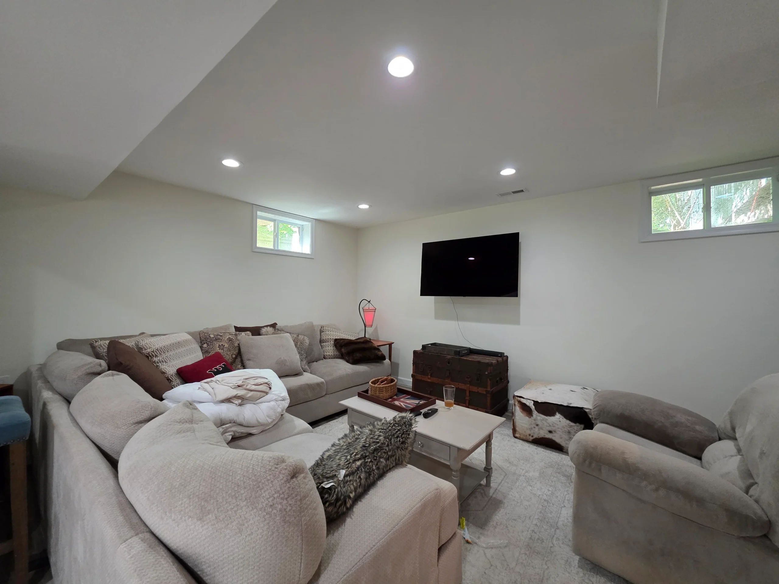 Finished lower-level living room with new flooring throughout