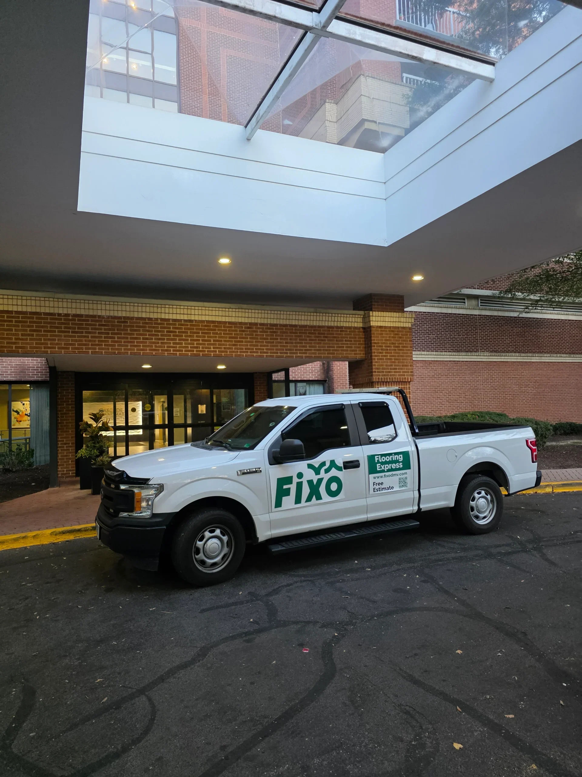 FIXO service truck parked at a DMV building entrance