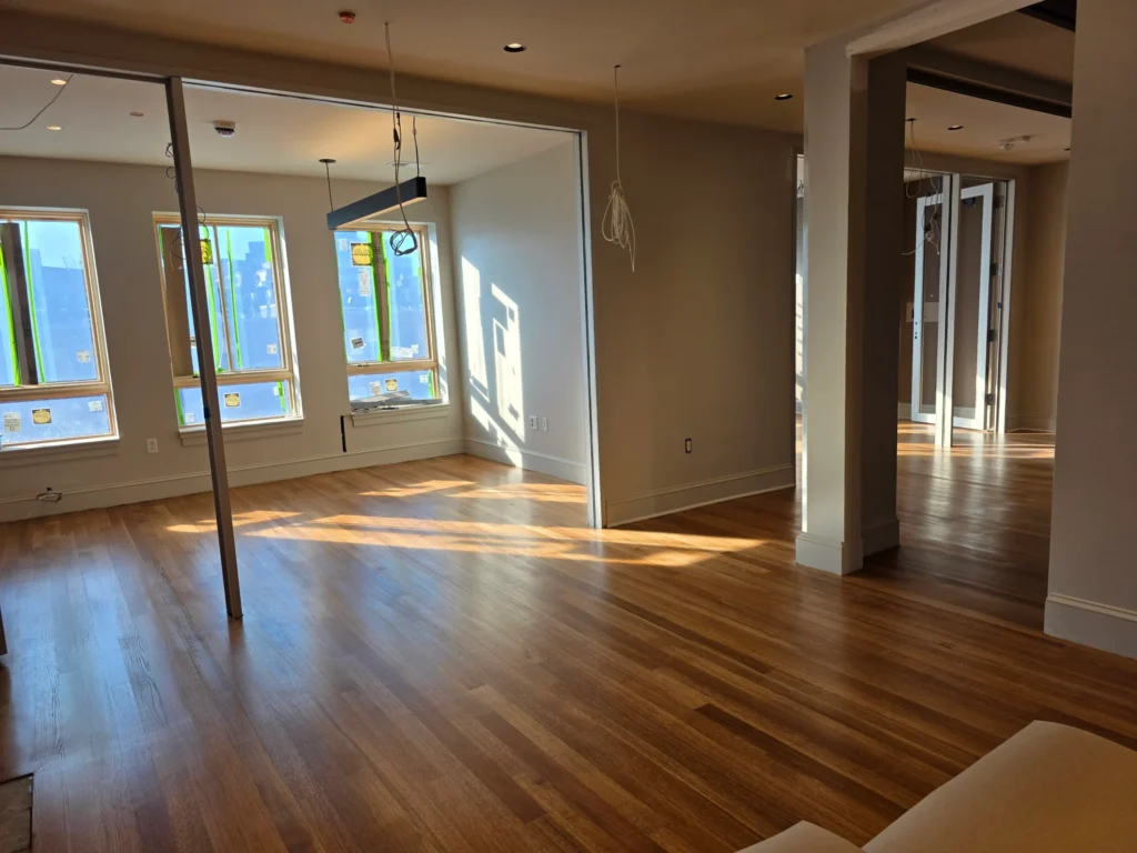 Finished wide-plank hardwood in a bright open room
