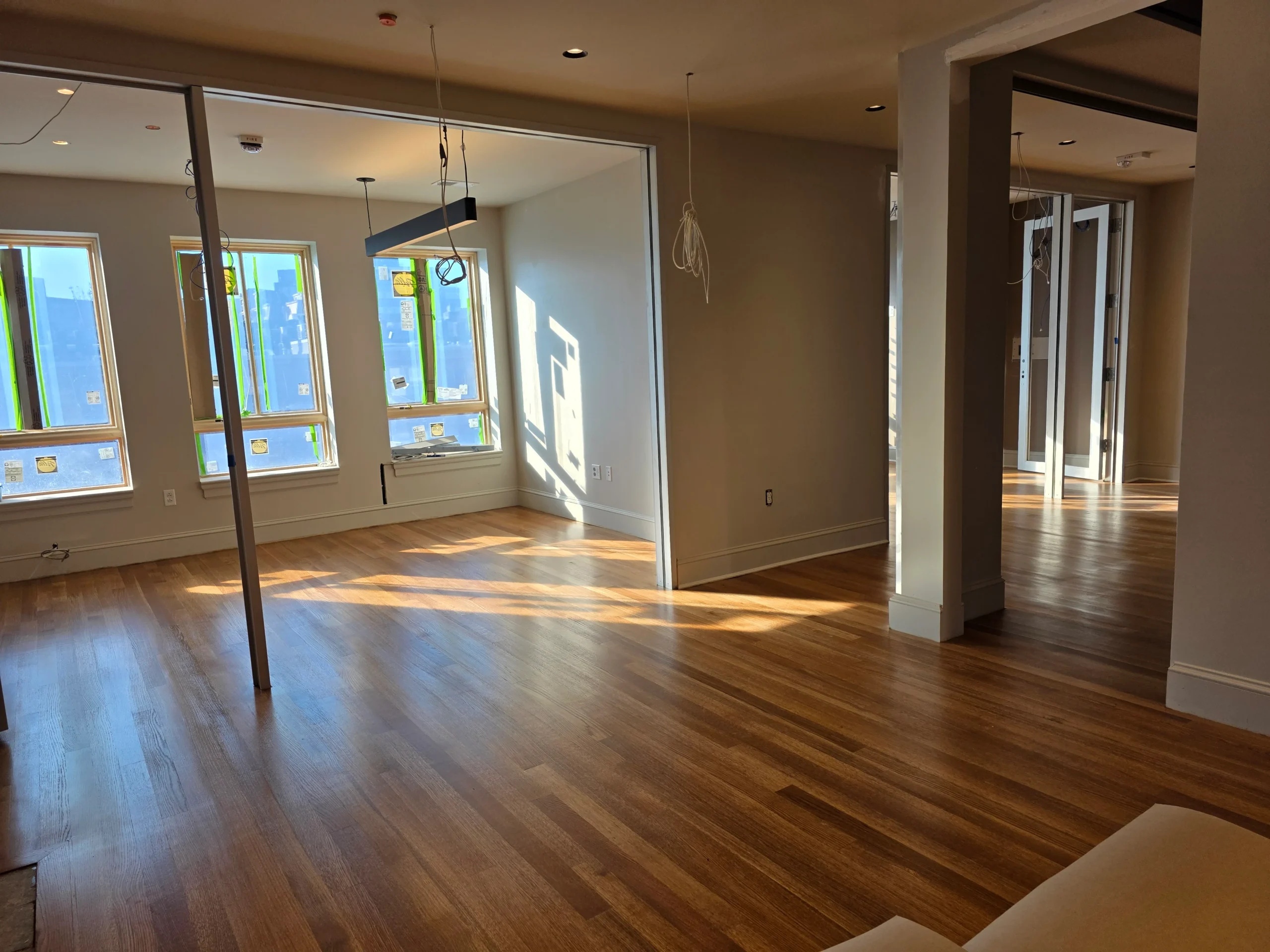Finished wide-plank hardwood in a bright open room