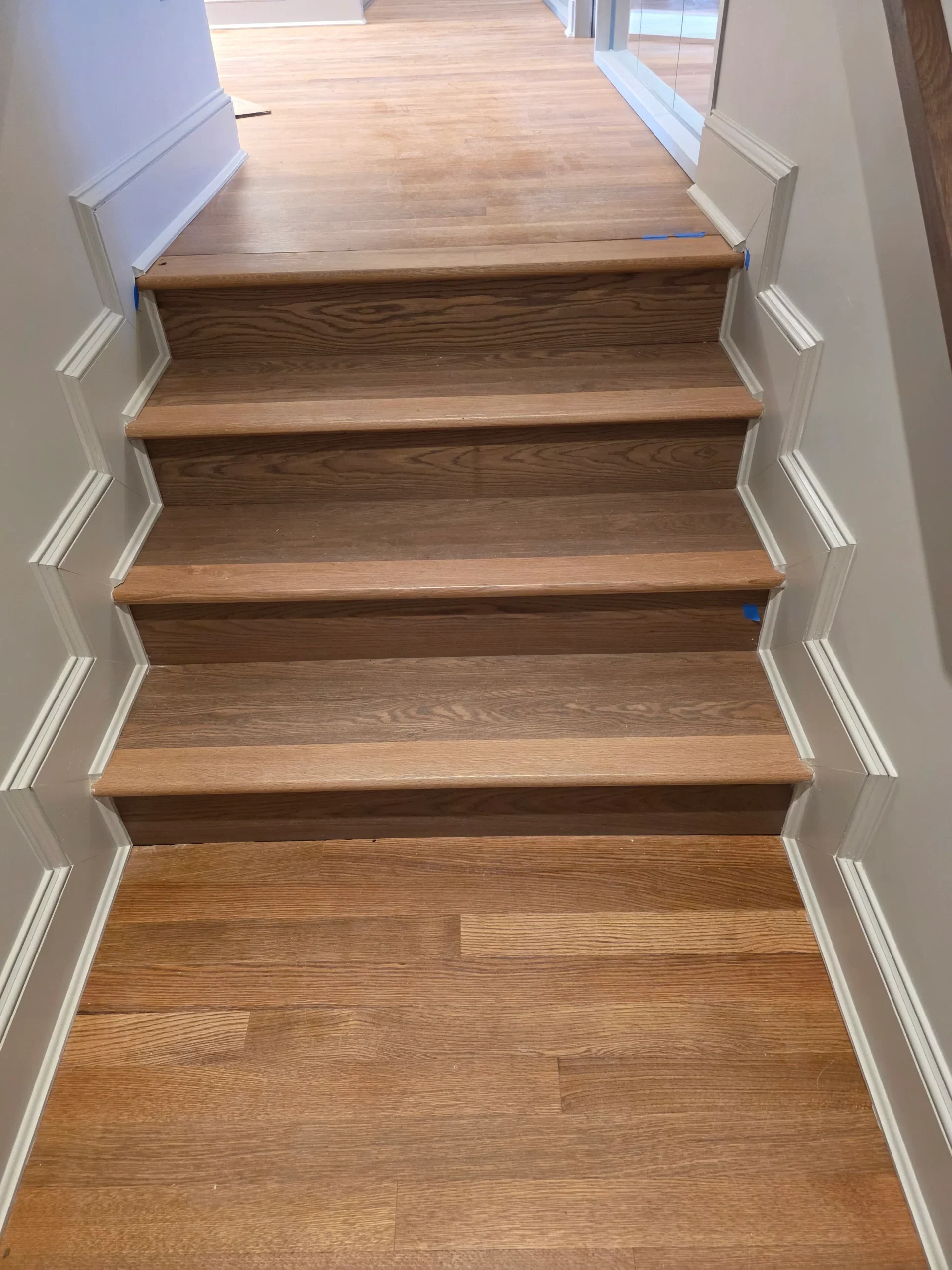 Wood stair treads with white risers, close view of the finished nosings