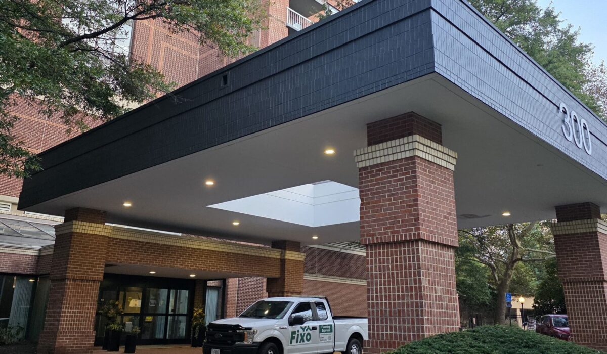 Installer truck outside a high-rise condominium, where carpet installation in Arlington needs building approval first