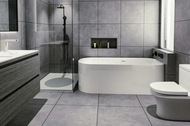 Bathroom floor tile installation finished in large grey tiles around a freestanding tub, vanity and toilet