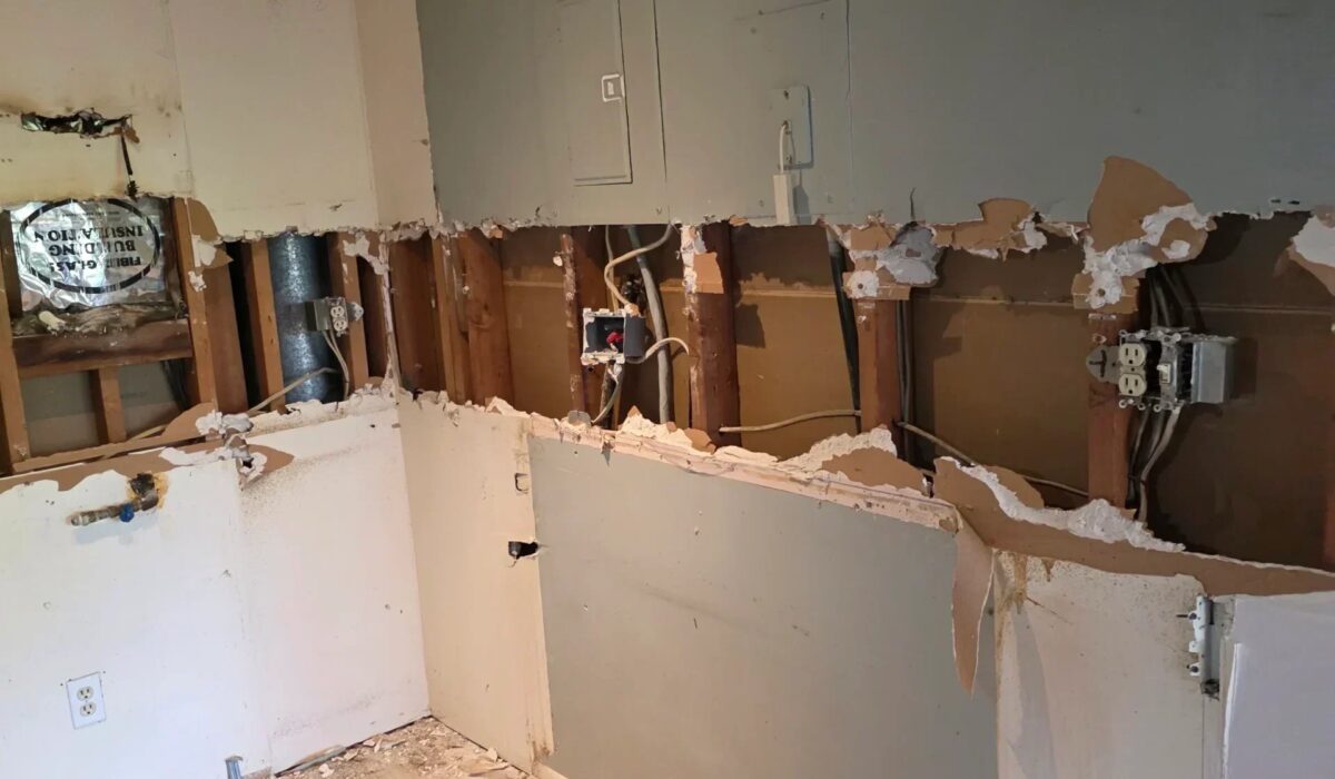 Bathroom wall opened up to the plumbing and wiring before new tile work