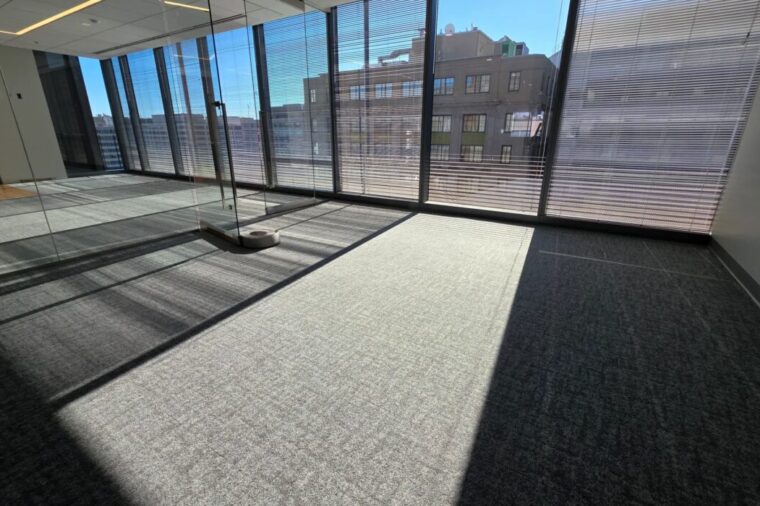 Carpet installation in Arlington office space with grey carpet tile and floor-to-ceiling windows