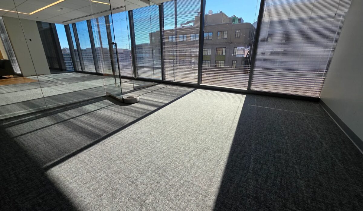 Carpet installation in Arlington office space with grey carpet tile and floor-to-ceiling windows