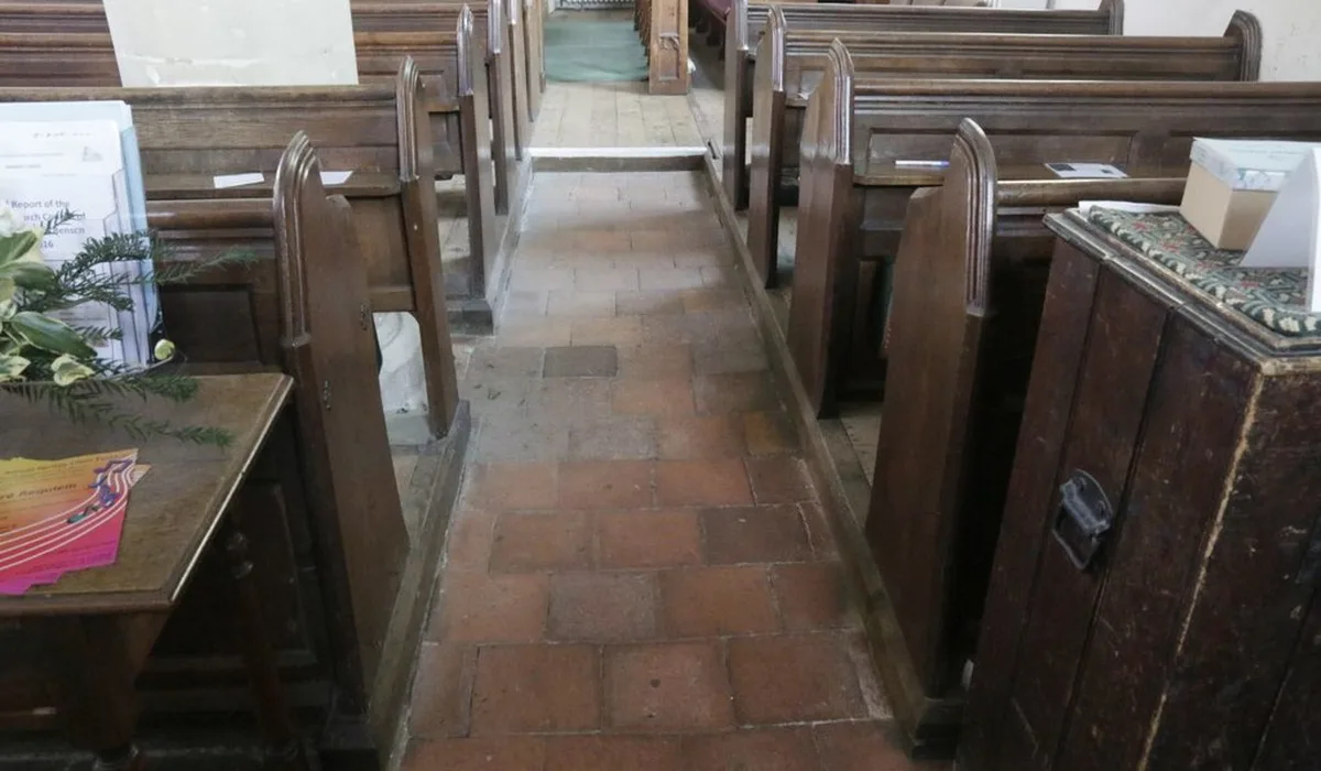 Commercial quarry tile installation: red square quarry tiles with wide grout joints