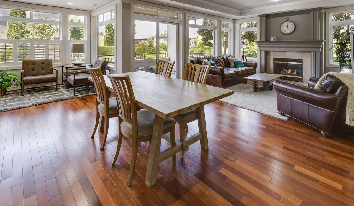 Finished wood look floor running through a dining and living room