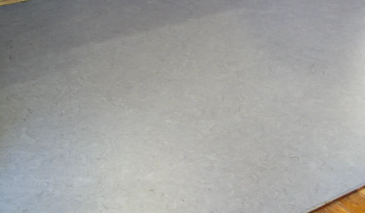 Plain grey sheet linoleum floor laid in one piece across a room