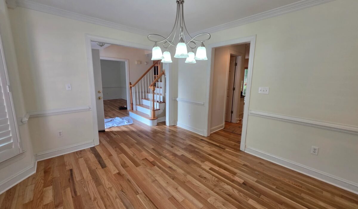 Hardwood floor installation in Fairfax colonial dining room with the staircase beyond