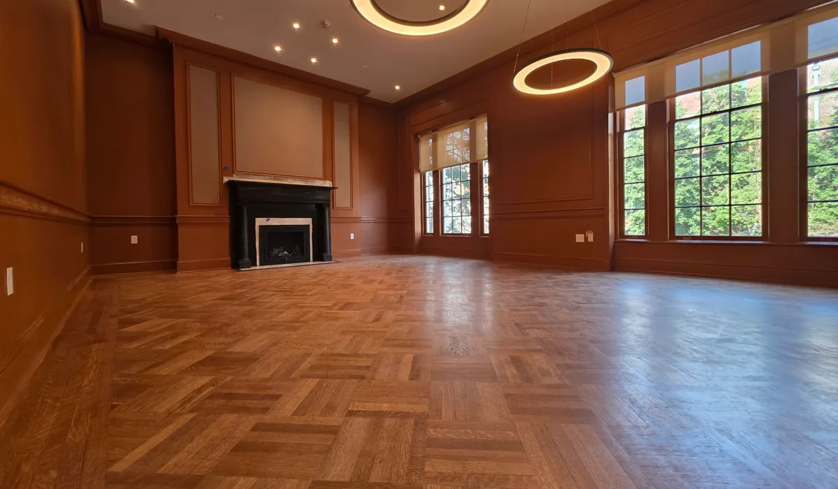 Herringbone parquet flooring running up to panelled walls