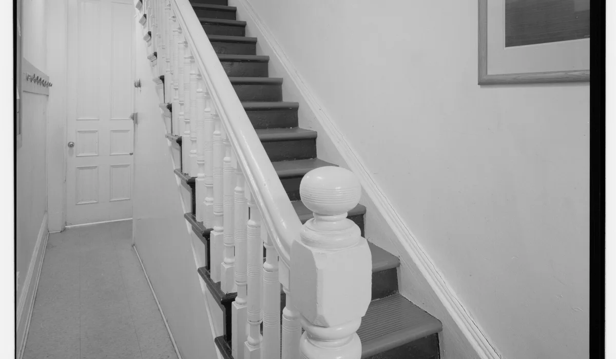 Historic rowhouse stair with balusters and a newel post, recorded by the Historic American Buildings Survey