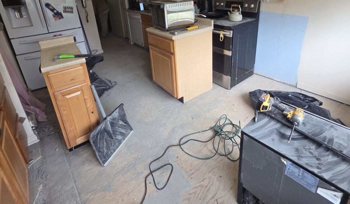 Kitchen cleared down to the subfloor before new floor tile goes in
