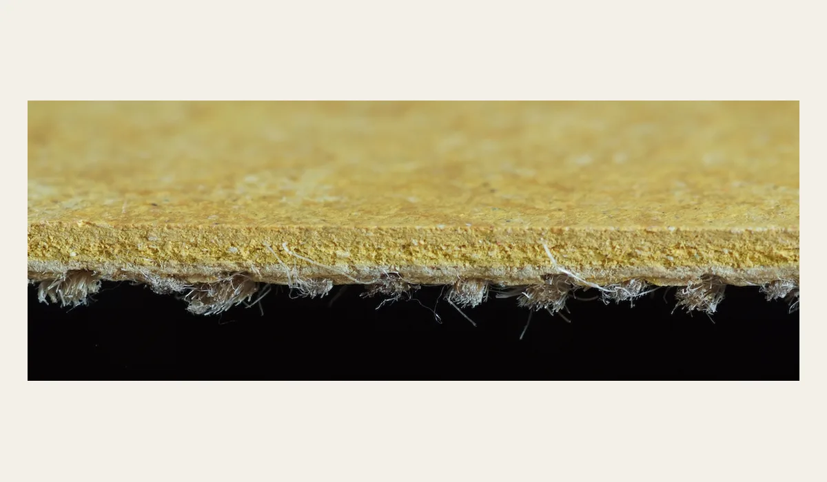 Cross-section of linoleum showing the linseed and wood-flour layer bonded to a woven jute backing