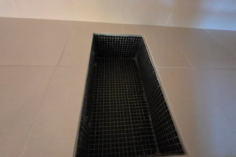 Northern Virginia waterproof flooring: large-format porcelain tile floor with a black mosaic shower pan