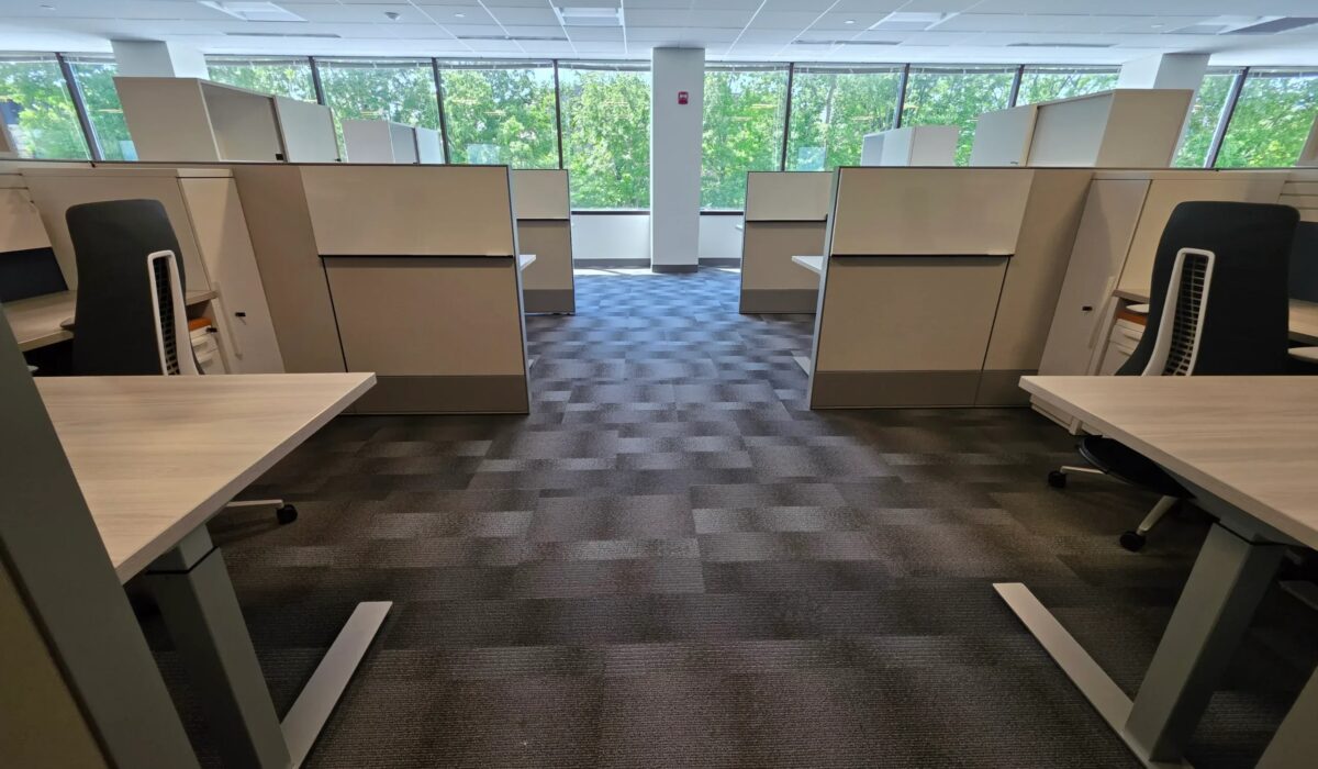 Office workstations set on patterned carpet tile in two tones