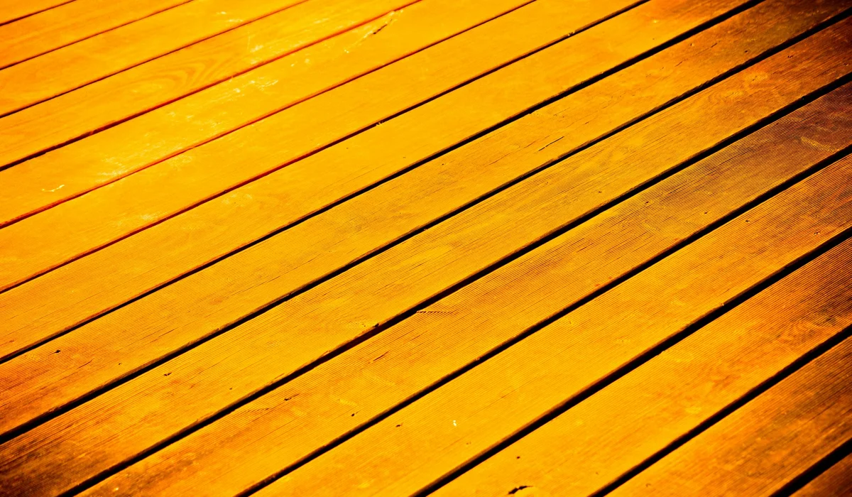 Close-up of a wood-grain plank floor catching the light