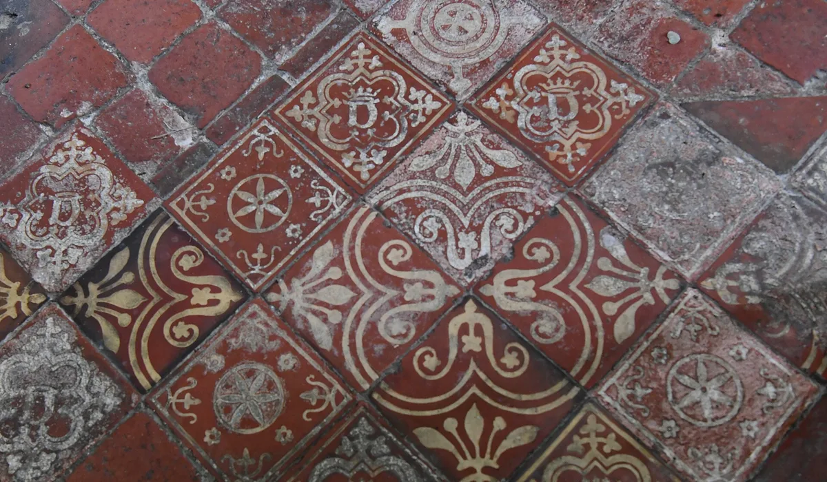 Close view of worn red quarry floor tiles
