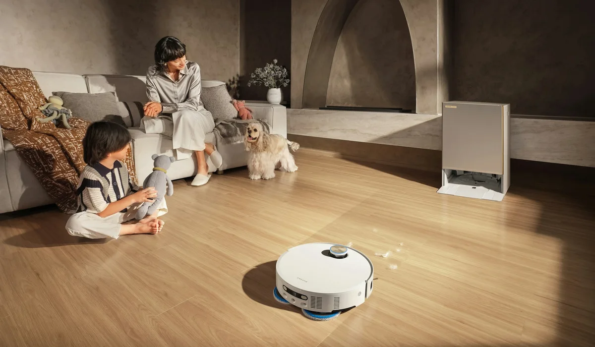 Robot vacuum cleaning a wood look floor while a family and dog relax