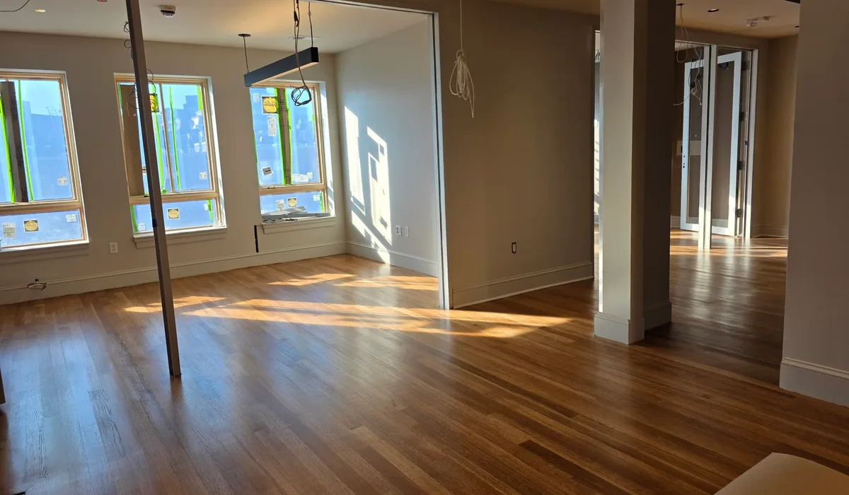 Wide-plank hardwood laid in a straight pattern, for comparison with herringbone