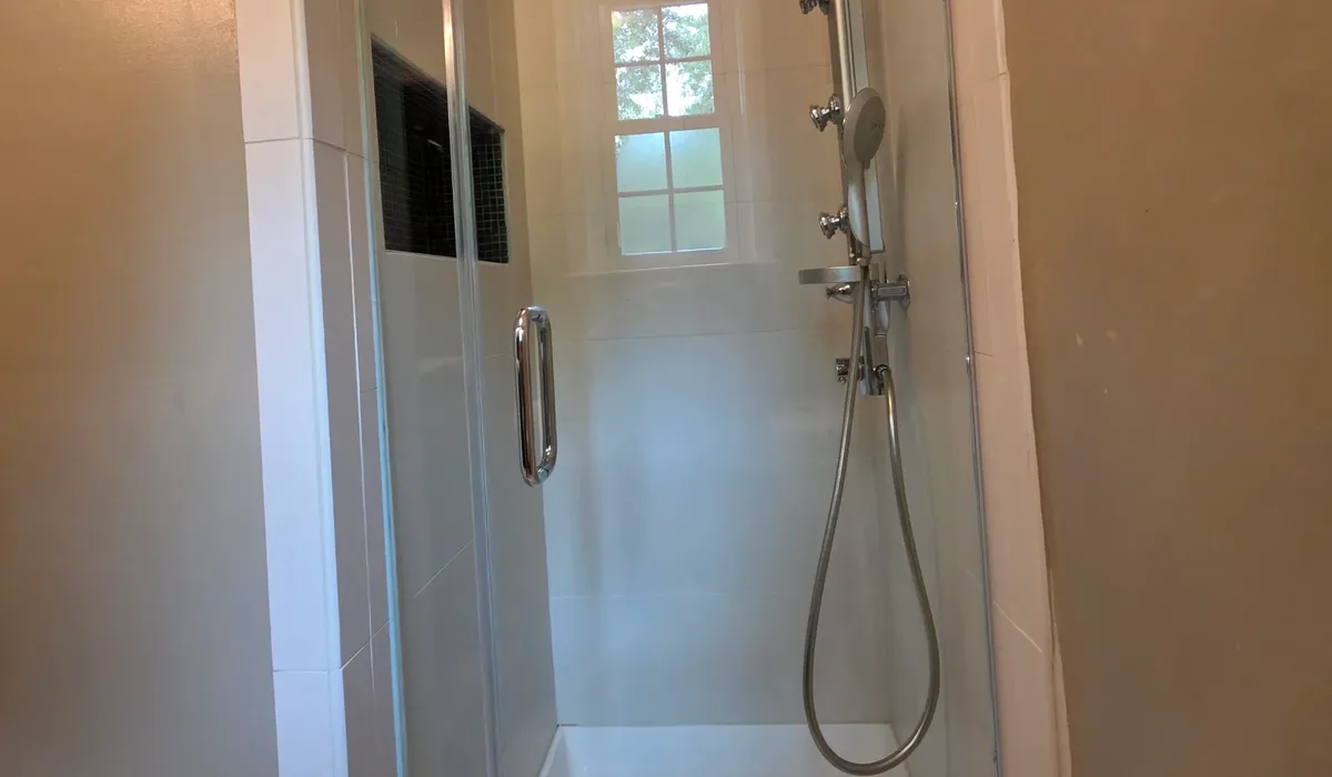 Finished tiled shower with a glass door installed by FIXO