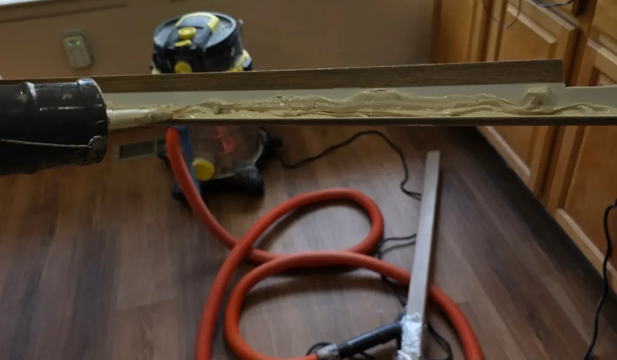 Luxury vinyl plank going down in a kitchen with installation tools on the floor