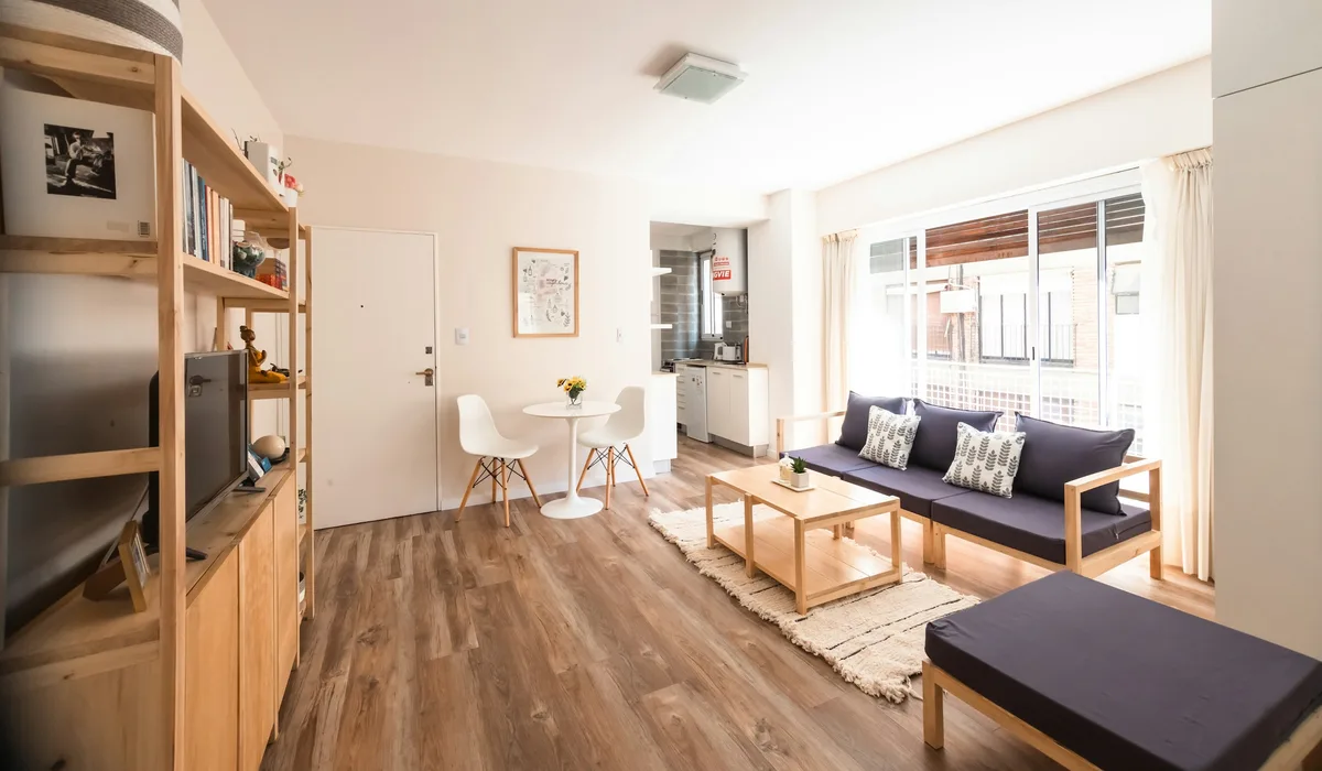 Light oak plank floor in an open living room, the look most vinyl wood flooring is designed to copy